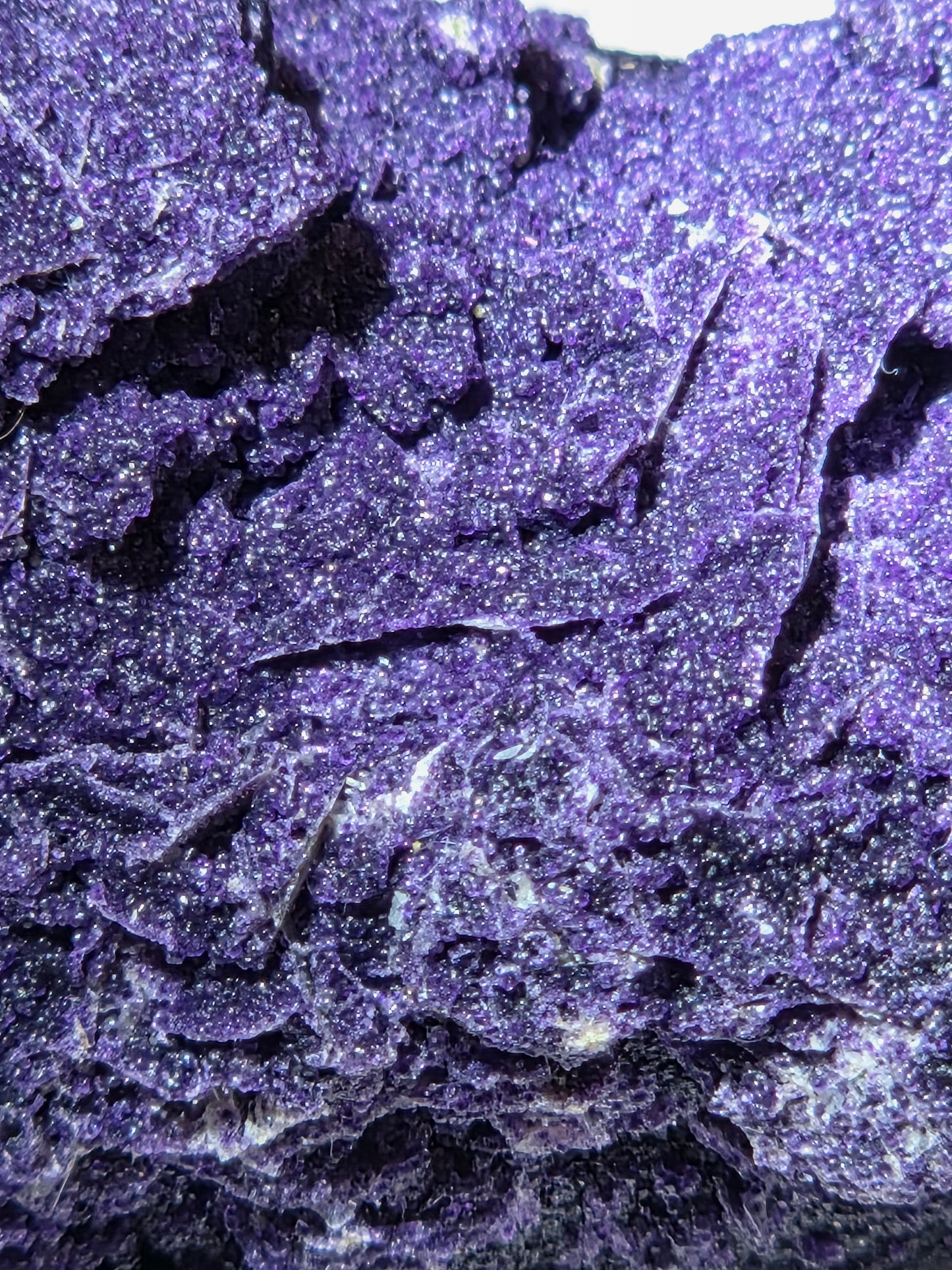 A close-up of purple fluorite covered quartz points