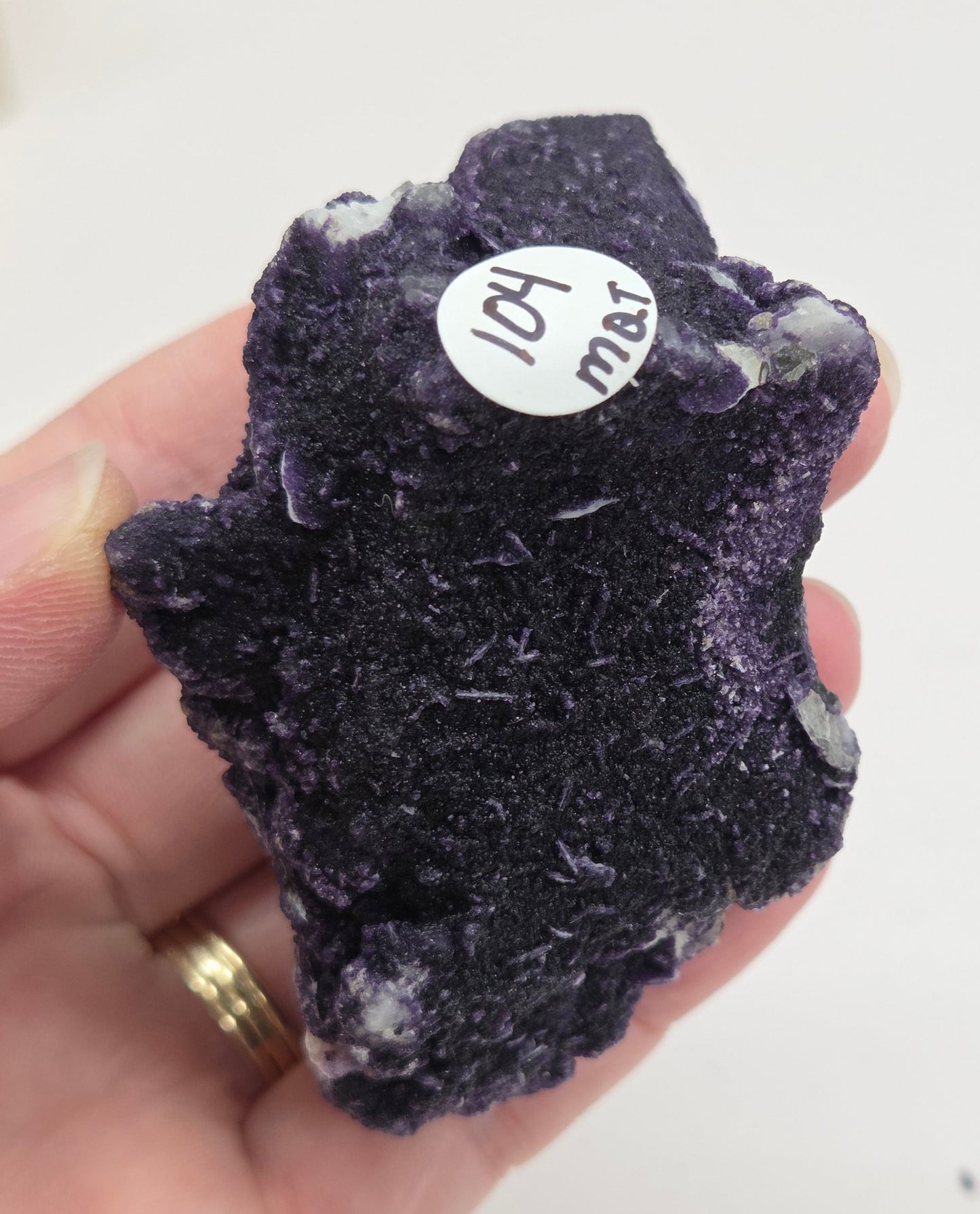 A collection of purple fluorite covered quartz points