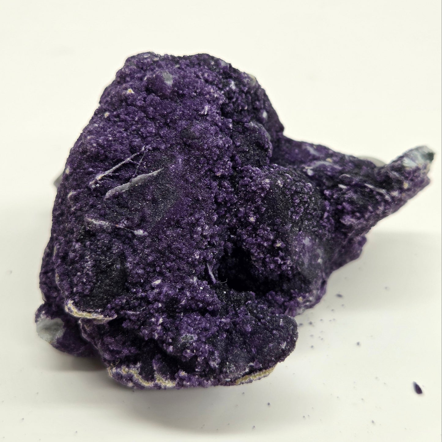 A collection of purple fluorite covered quartz points