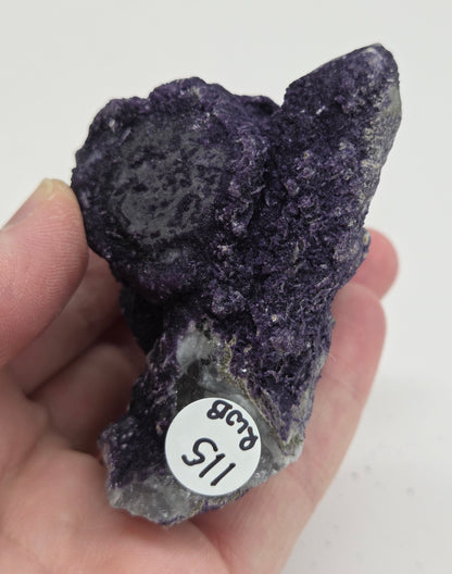 A collection of purple fluorite covered quartz points