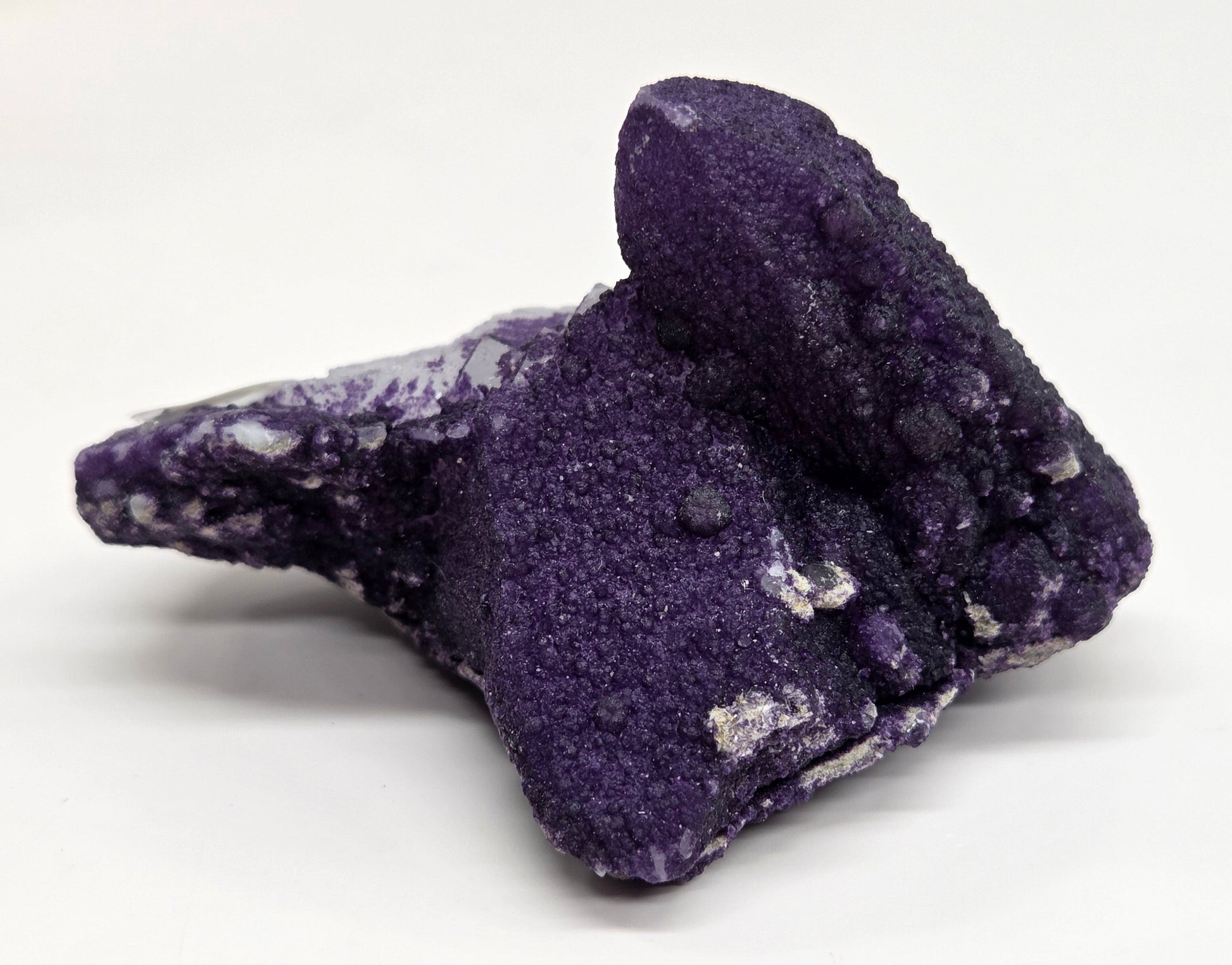 A collection of purple fluorite covered quartz points