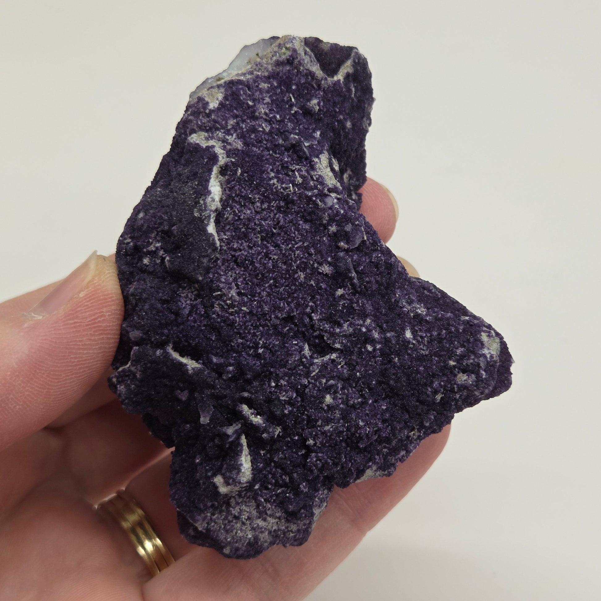 A collection of purple fluorite covered quartz points