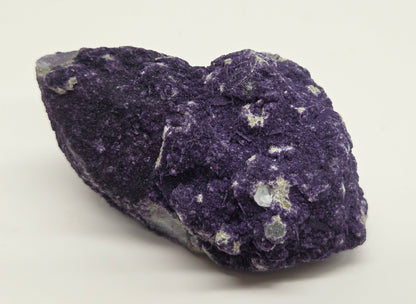 A collection of purple fluorite covered quartz points