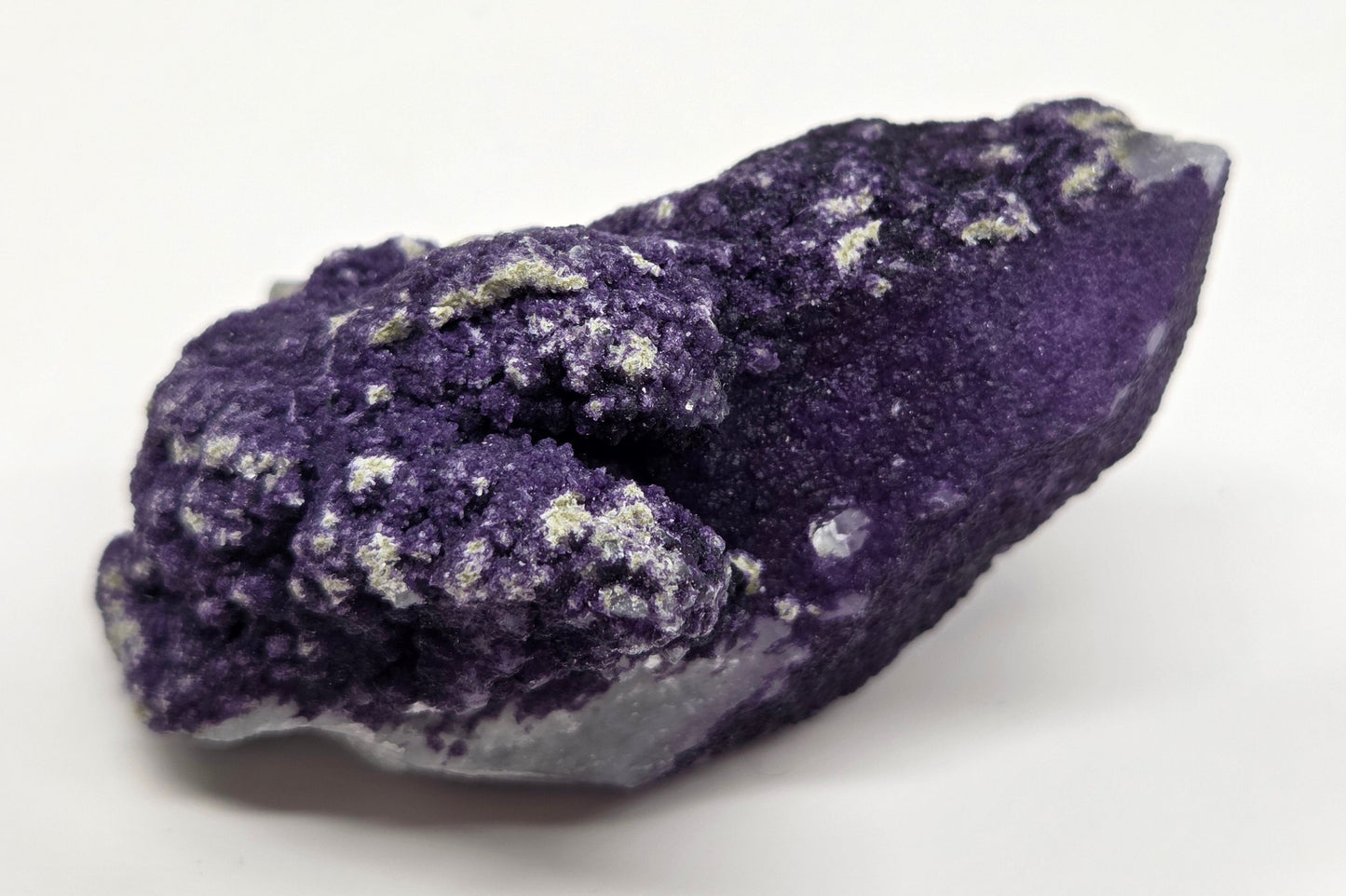 A collection of purple fluorite covered quartz points