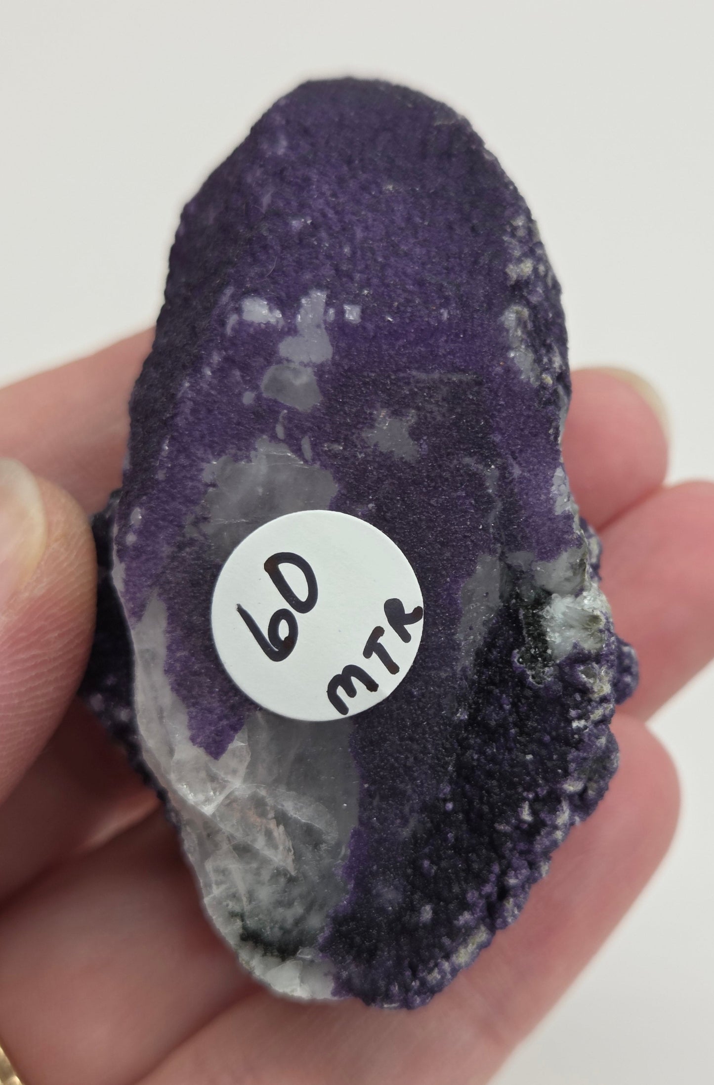 A collection of purple fluorite covered quartz points