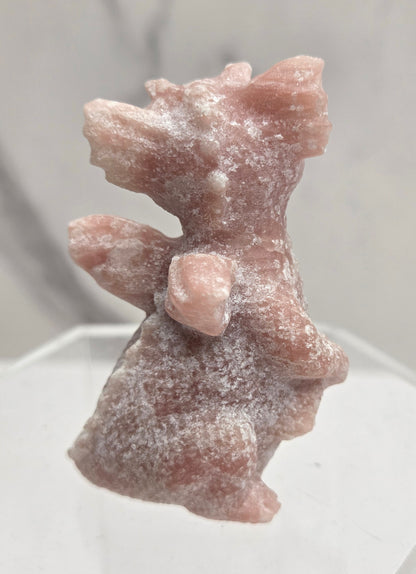 Small pink dragon-shaped object on a white background