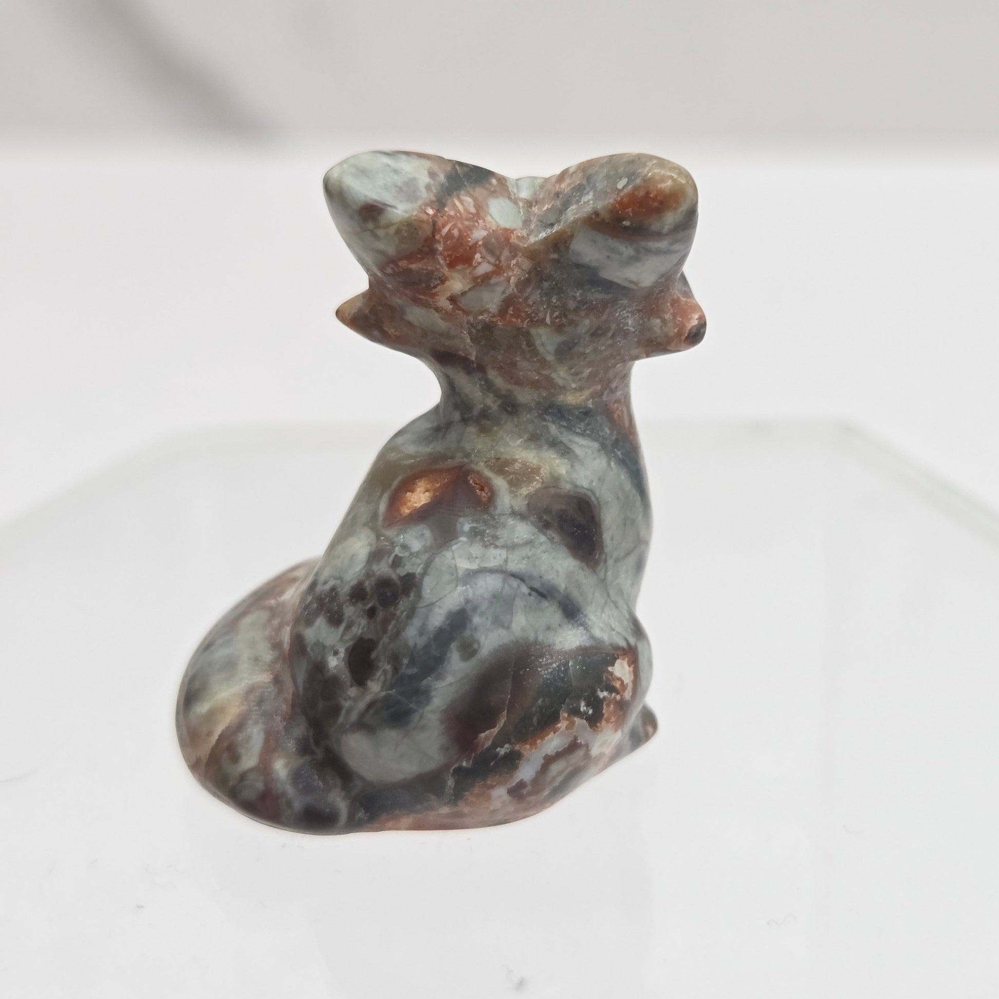 Money Agate fox carving with grey, yellow and red coloring on a white background