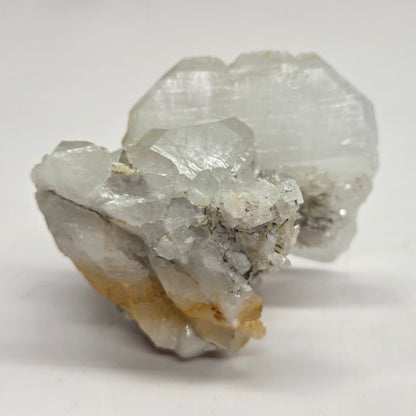 A clear quartz crystal with a white thread-like line running through it, showcasing the properties of Faden Quartz.
