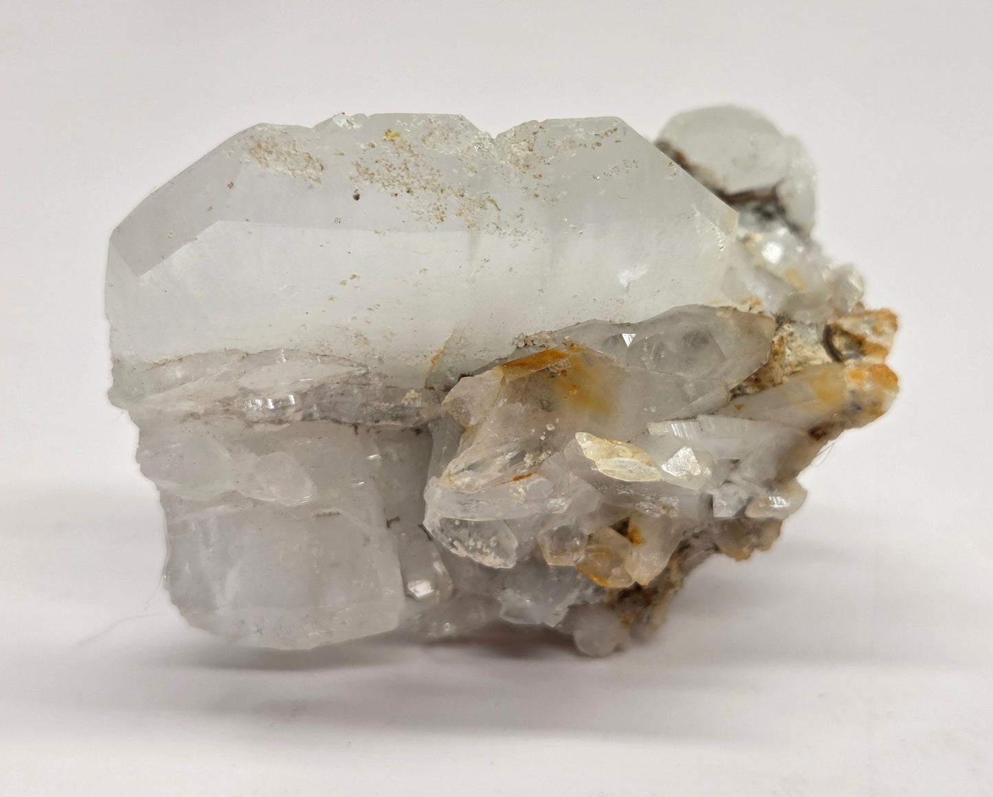 A clear quartz crystal with a white thread-like line running through it, showcasing the properties of Faden Quartz.