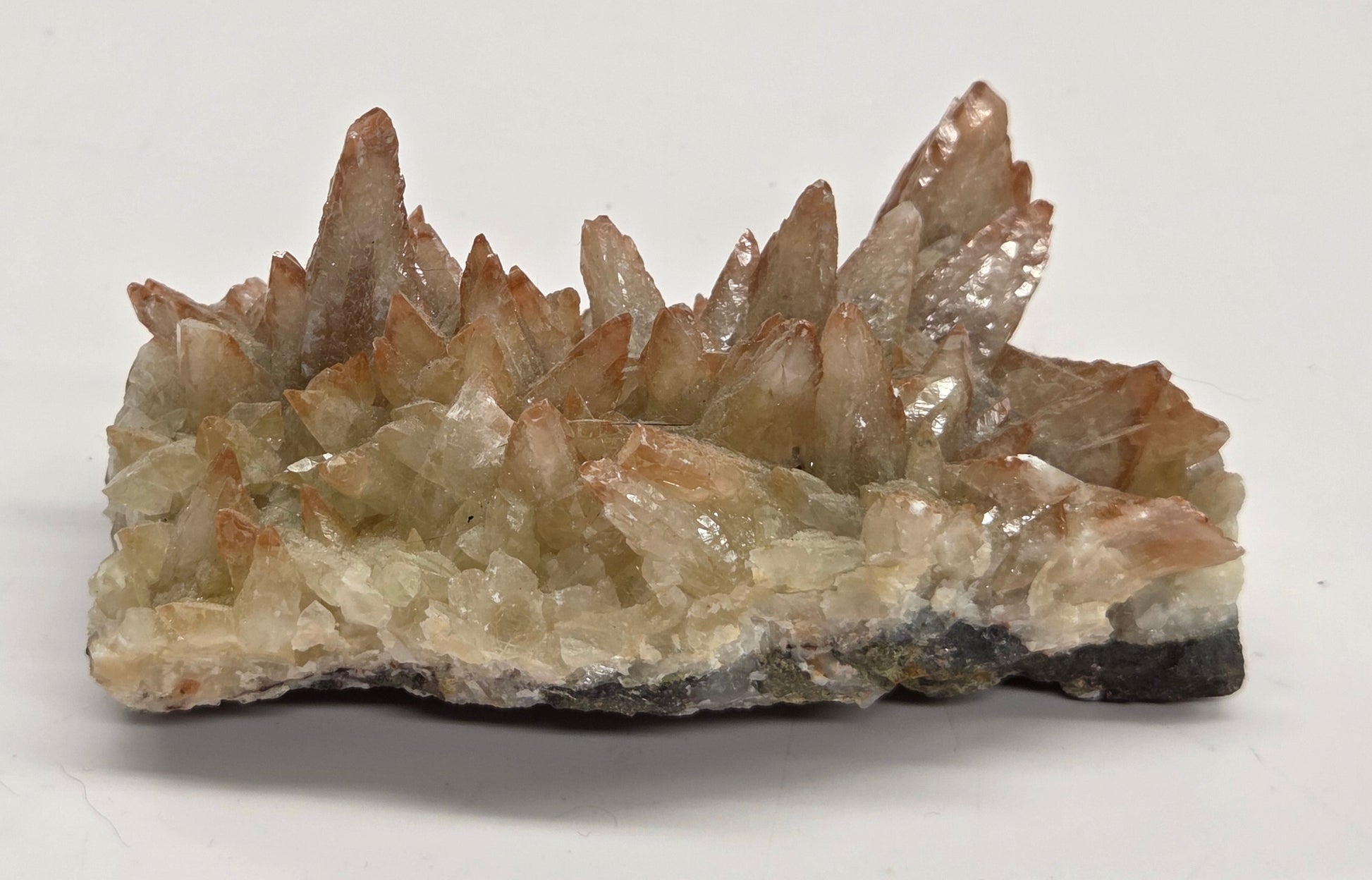 Mineral specimen with crystal formations on a white background