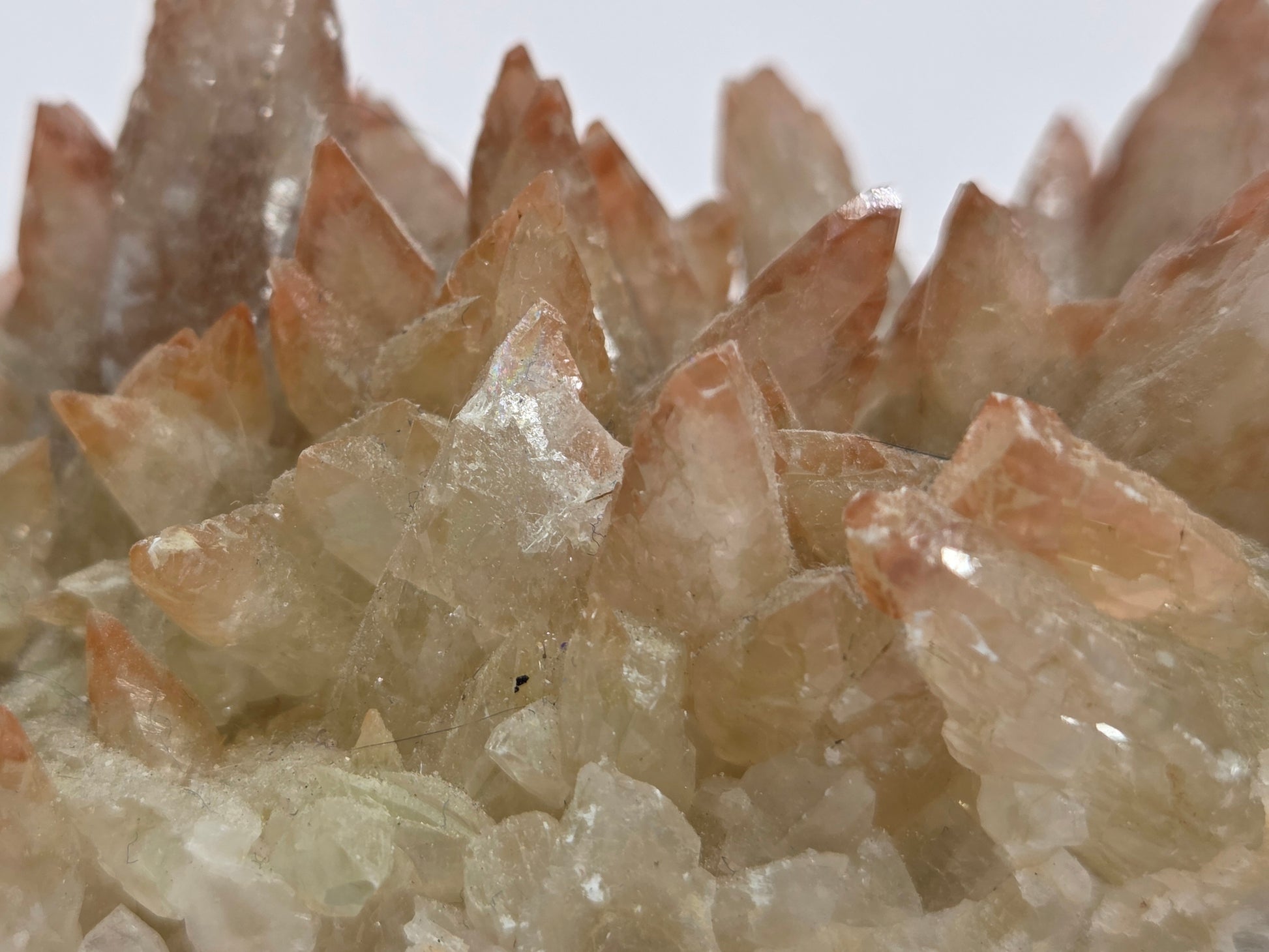 Close-up of a crystal formation with clear and brownish crystals.