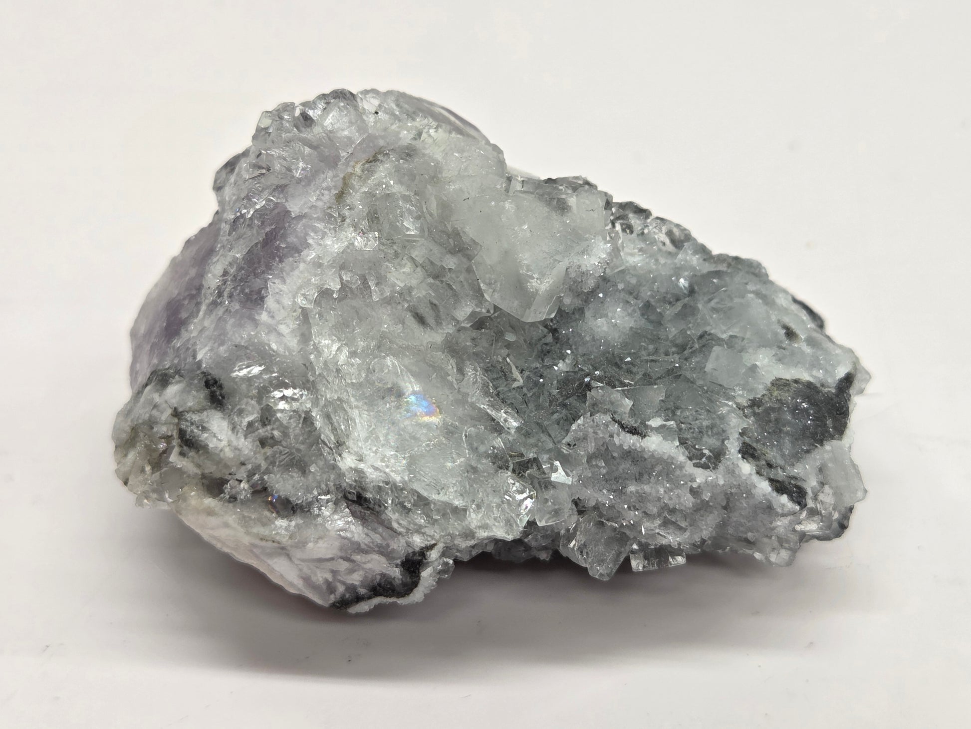Purple Fluorite specimen against a white background