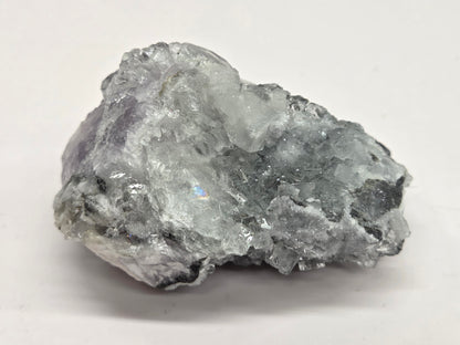 Purple Fluorite specimen against a white background