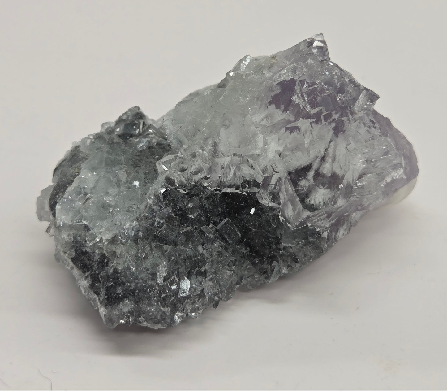 Purple Fluorite specimen against a white background