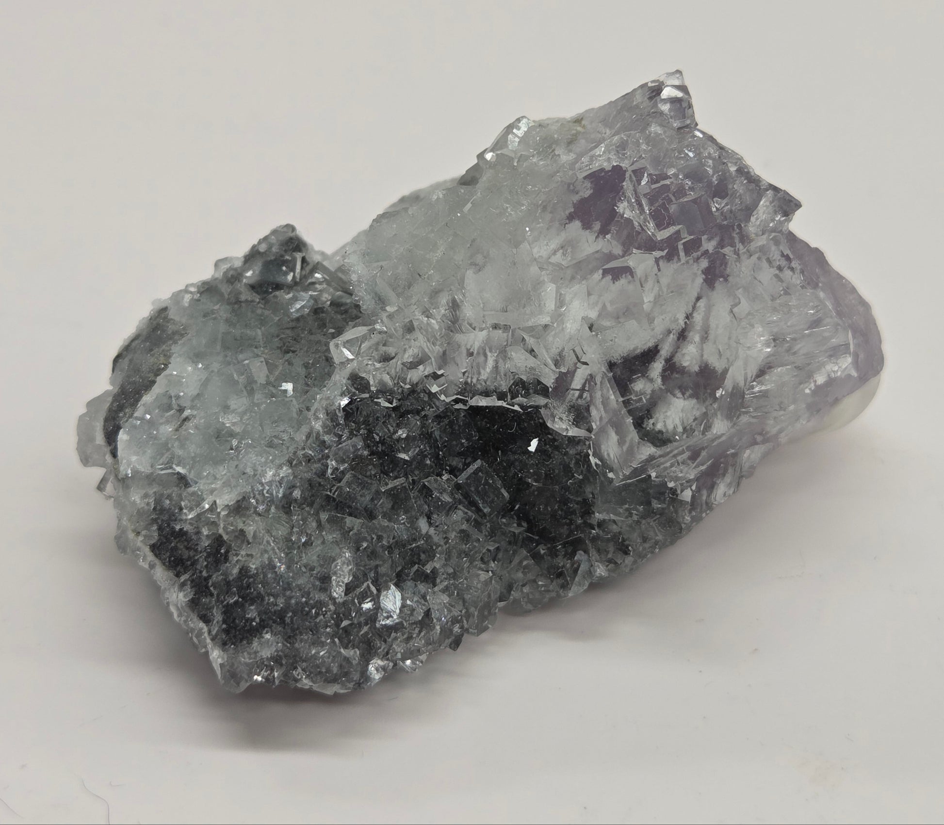 Purple Fluorite specimen against a white background
