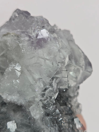 Purple Fluorite specimen against a white background