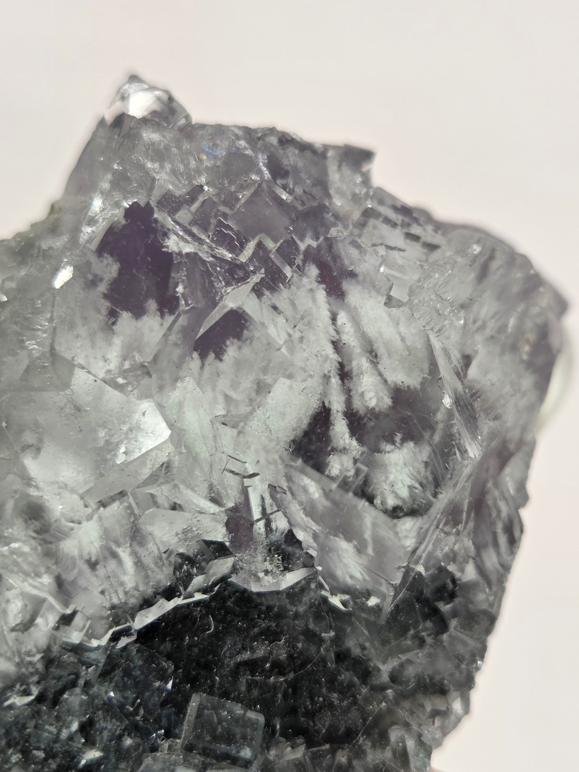 Close-up of a crystal or mineral sample on a light background