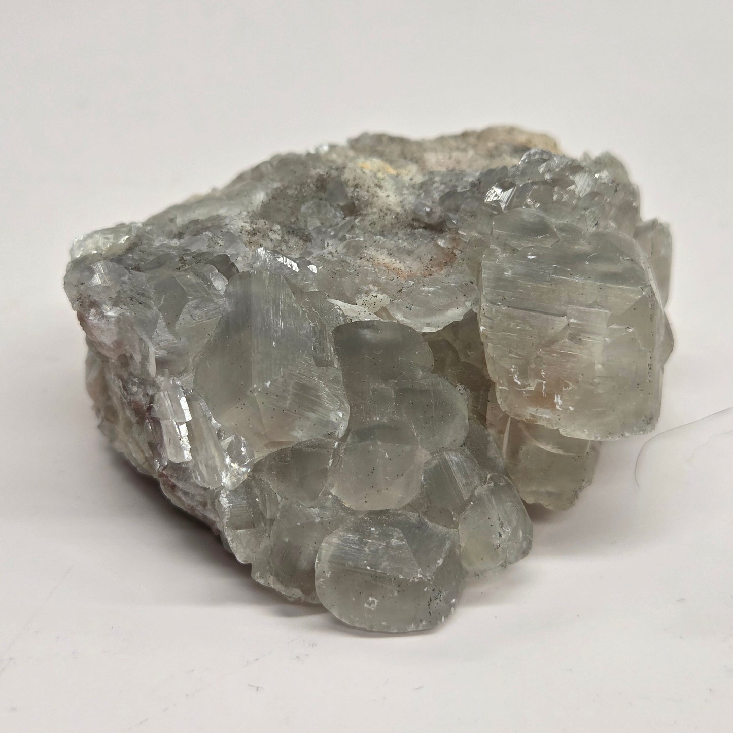 A rough, unpolished Money Calcite mineral from Hubei, China, with a translucent appearance and crystal-like formations.