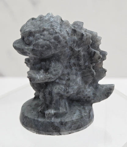 Larvikite Godzilla carving on a white background