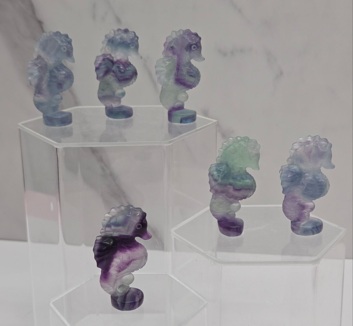 Fluorite crystal seahorse carvings with blue, green and purple colors