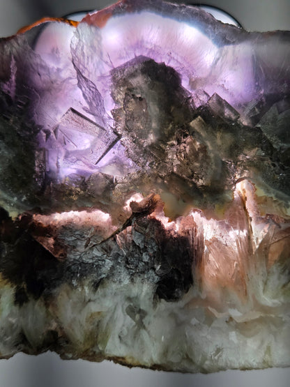 Close-up of a mineral specimen with purple and white colors