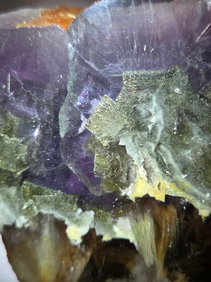 Close-up of a crystal with purple and green colors