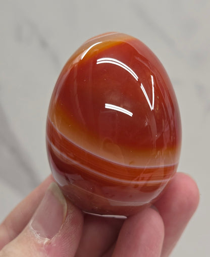 Marbled red and white Carnelian egg carving