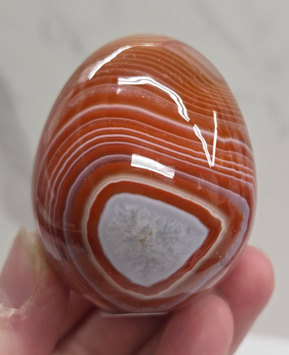 Marbled red and white Carnelian egg carving