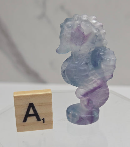 Fluorite crystal seahorse carvings with blue, green and purple colors