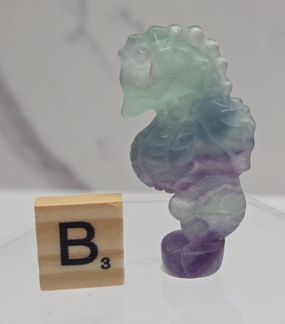 Fluorite crystal seahorse carvings with blue, green and purple colors