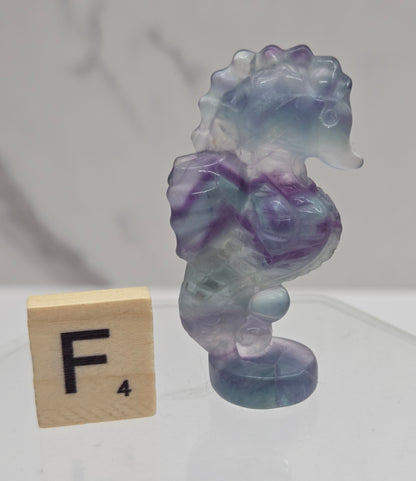 Fluorite crystal seahorse carvings with blue, green and purple colors