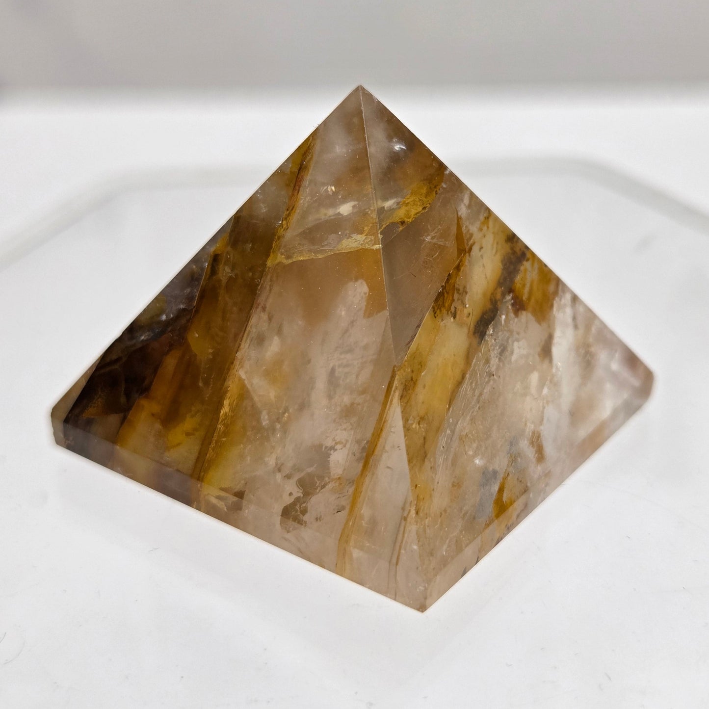 Golden Healer pyramid carving with browns and yellows