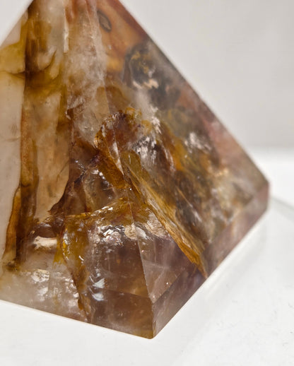 Close-up of a Golden Healer crystal on a white background