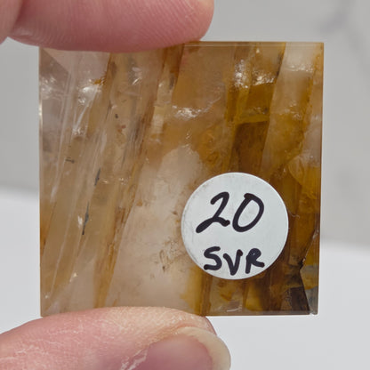 Bottom of Golden Healer pyramid carving with browns and yellows and label