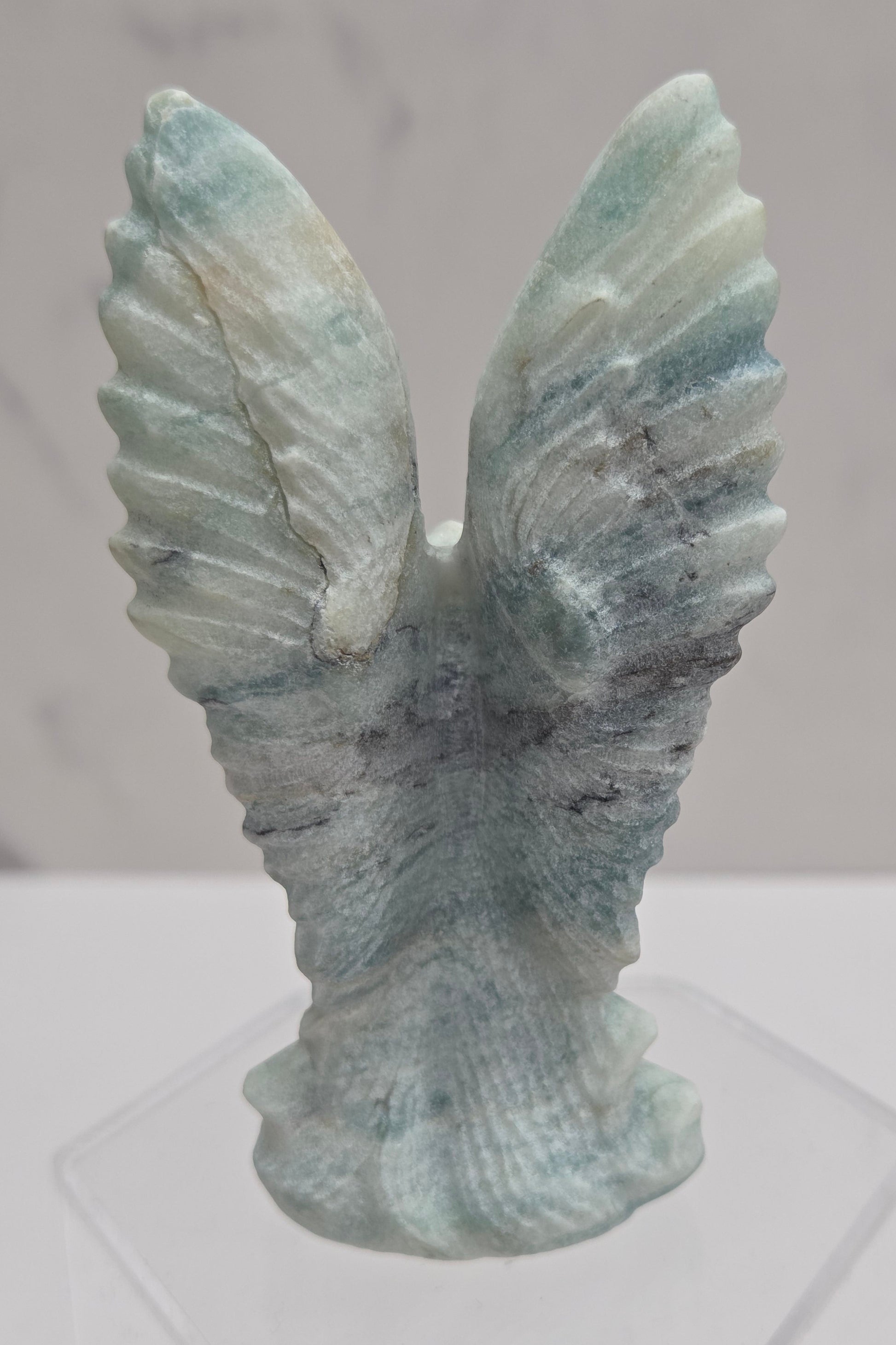 Back side of Blue Calcite crystal angel carving with blue and white banding