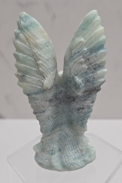 Back side of Blue Calcite crystal angel carving with blue and white banding