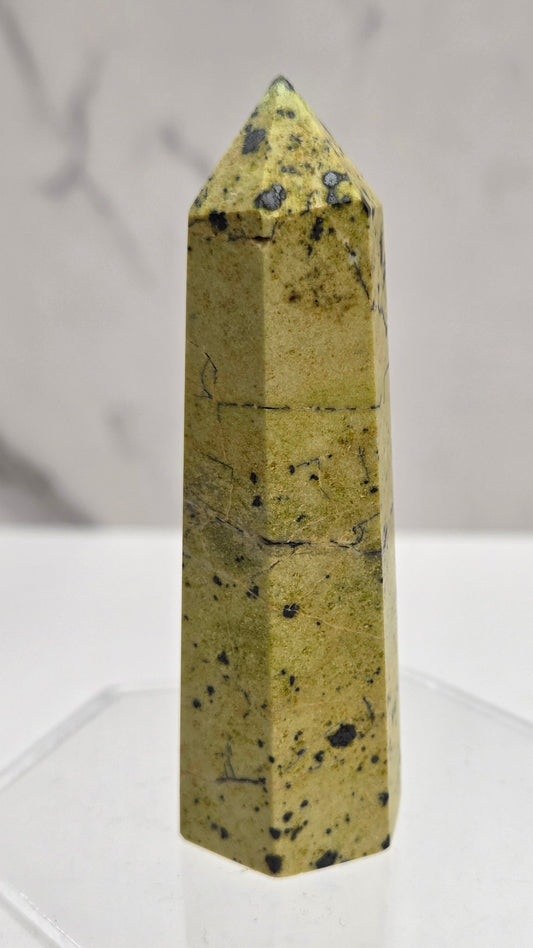 Carved Septarian tower with greenish yellow color and black dots