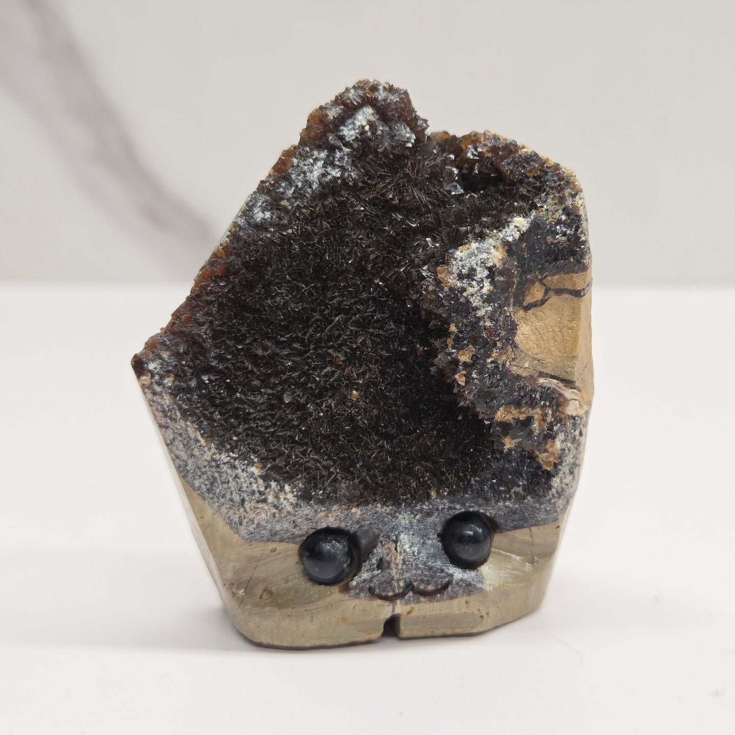 Mineral sample with dark interior and gray exterior on a white background