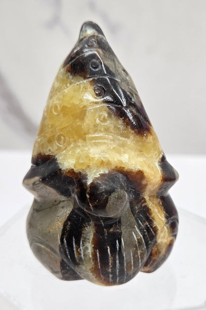 Carved Septarian gnome carving with yellow, brown and tan coloring
