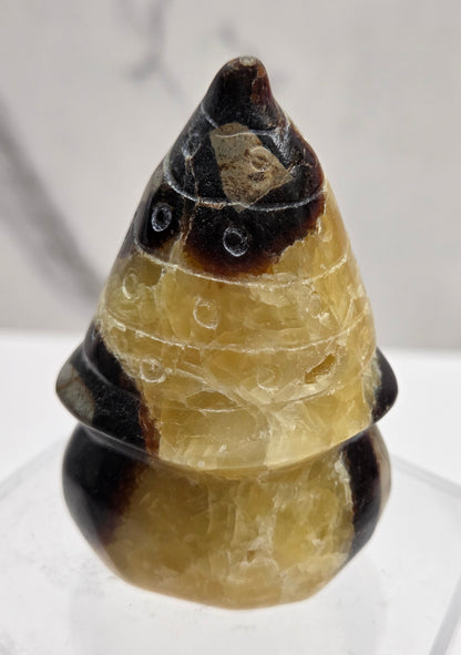 Carved Septarian gnome carving with yellow, brown and tan coloring