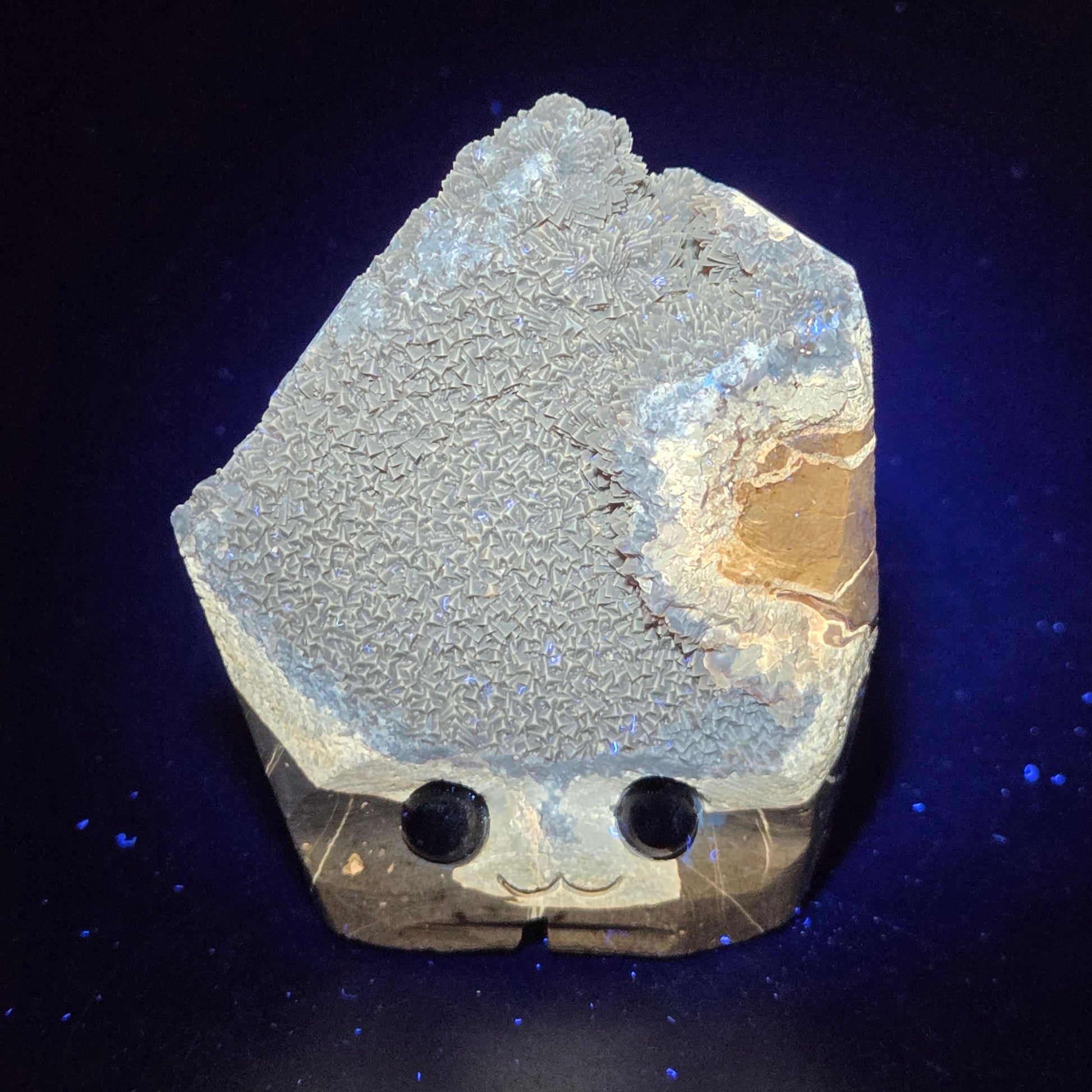 Geode with crystal formation on a dark background