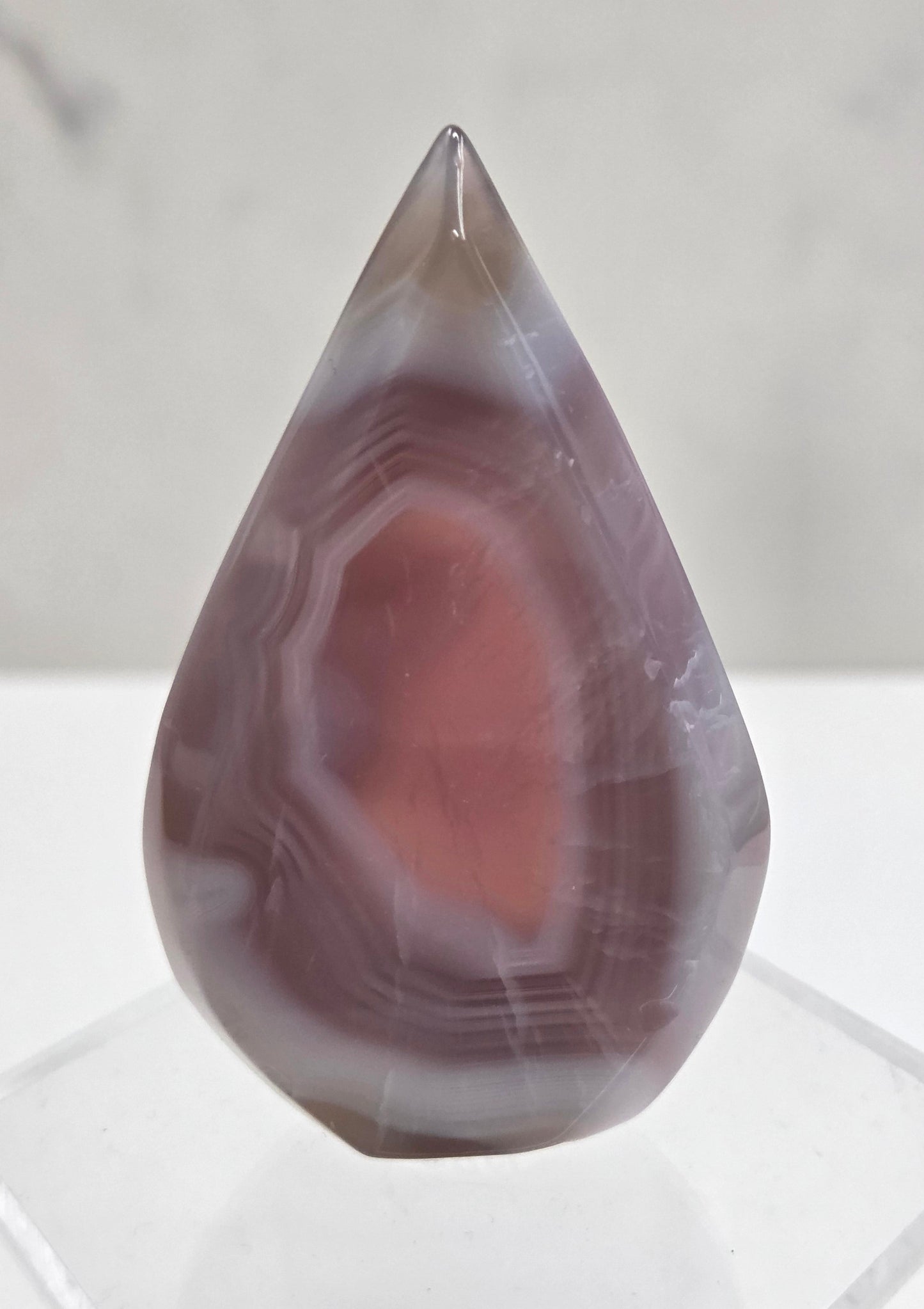 Polished Jelly Agate teardrop crystal with marbled pattern on a white background