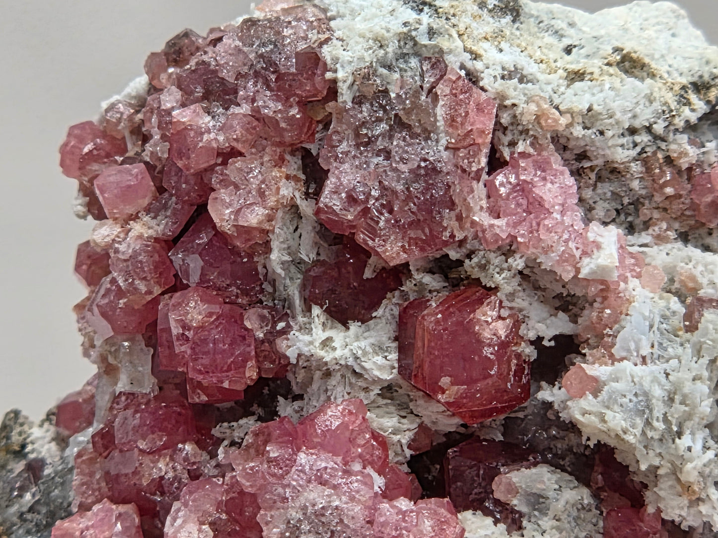 Close-up of pink crystal formations on a white background
