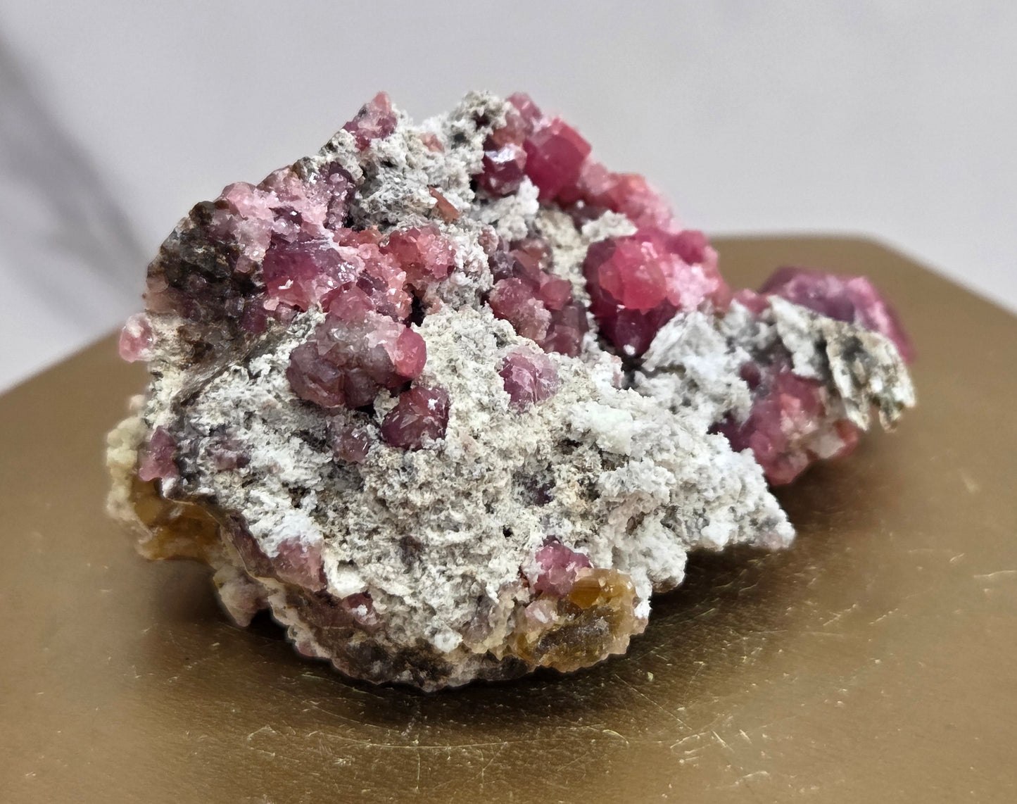 Mineral sample with pink crystals on a white background