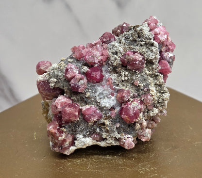 Mineral sample of Pink Garnet on white matrix