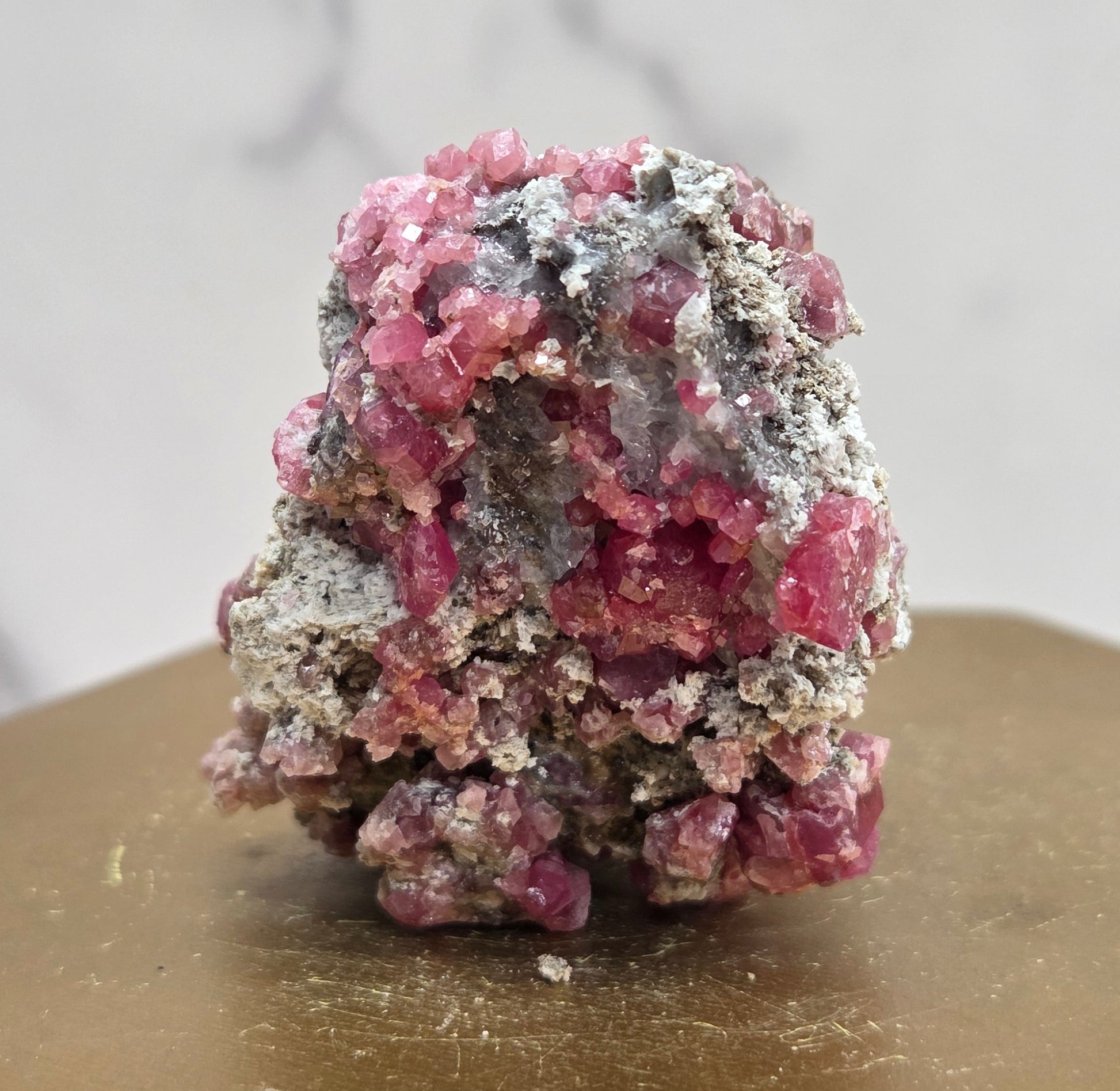 Mineral sample of Pink Garnet on white matrix