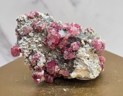 Mineral sample of Pink Garnet on white matrix
