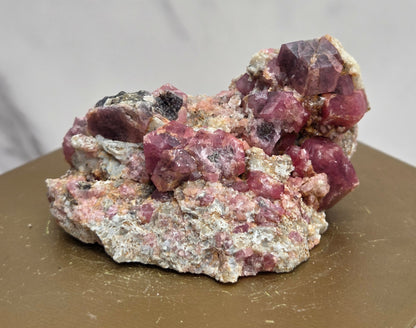 Mineral sample of Pink Garnet on white matrix