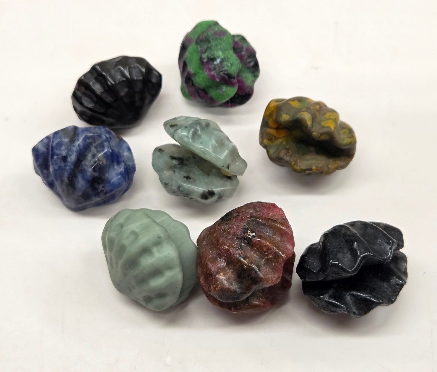 Collection of various crystal clam carvings on a white background