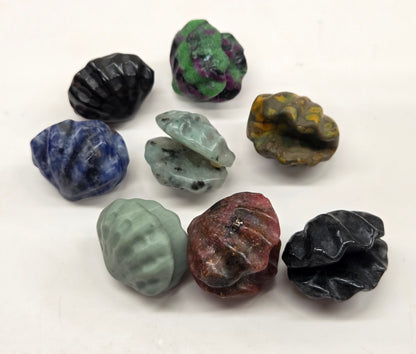 Collection of various crystal clam carvings on a white background